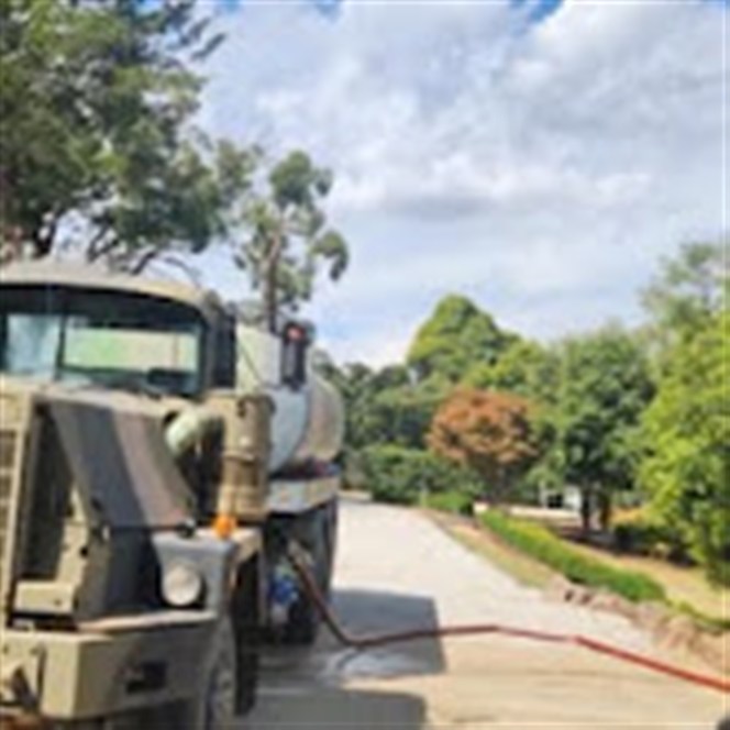 K.R water tanker on a rural road during a residential delivery